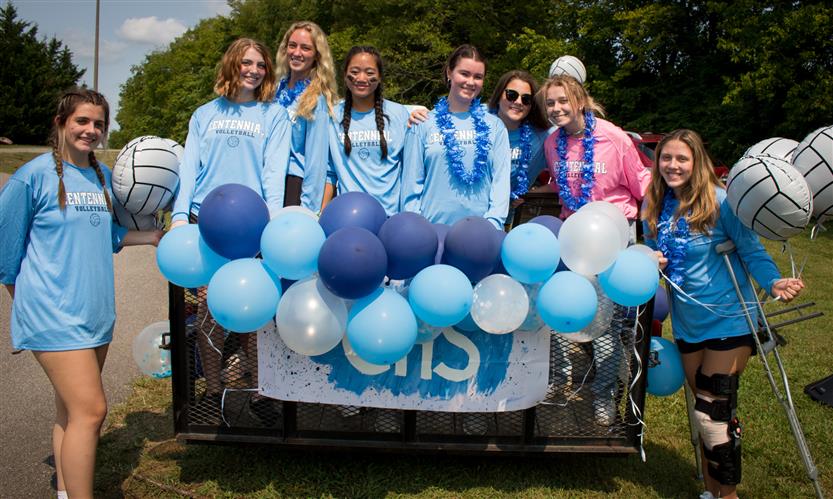 Students celebrate while on a homecoming parade float